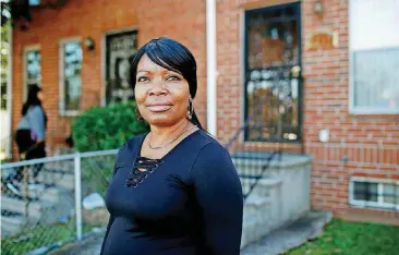  ?? [AP PHOTO] ?? Octavia Mason poses for a photo outside of her mother’s home in Baltimore. Mason’s drug use after a broken marriage caused her to lose her license to teach high schoolers to become pharmacy technician­s. Now she participat­es in a program called “Turnaround Tuesday” that helps people with criminal records, struggles with drug addiction, or simply a life of poverty find a living wage job.