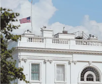  ?? AP PHOTO ?? UP-AND-DOWN: The flag atop the White House flew at half-staff over the weekend but was raised Monday and then lowered again amid criticism.