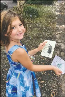  ??  ?? Cate Carroll shows off letters she’s received from fairies.