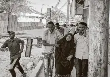  ?? Associated Press ?? People flee the area as gunshots are heard on a street near the Afrik hotel in Mogadishu, Somalia, on Sunday.