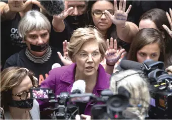  ?? J. SCOTT APPLEWHITE/AP FILE PHOTO ?? Sen. Elizabeth Warren, D-Mass., greets women’s-rights activists in the Hart Senate Office Building on Sept. 27.