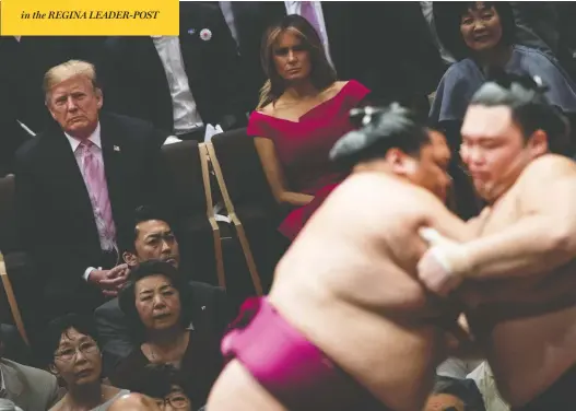  ?? BRENDAN SMIALOWSKI / AFP / GETTY IMAGES ?? U.S. President Donald Trump and wife Melania watch sumo wrestling in Tokyo on Sunday. The president presented a hulking 27-kilogram trophy to the tournament champion.