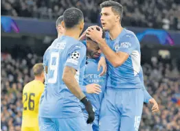  ?? AP ?? Manchester City’s Raheem Sterling (centre) is greeted by teammates after scoring his side’s third goal during the Champions League Group A match against Club Brugge at the Etihad Stadium in Manchester, England, on Wednesday.