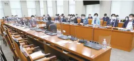  ?? Yonhap ?? Seats for lawmakers of the main opposition People Power Party are empty after they walked out in protest against the ruling Democratic Party of Korea’s decision to pass a bill to expand the substitute holiday system, which excluded businesses with five or fewer employees, during a meeting of the National Assembly Interior and Safety Committee, Wednesday.