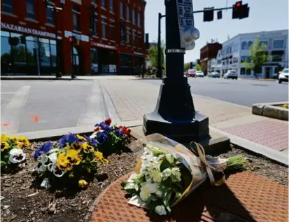 ?? PAT GREENHOUSE/GLOBE STAFF ?? A bouquet was left near the crosswalk where a 6-year-old was killed by a large truck, at Main and Elm streets, in Andover Tuesday night.