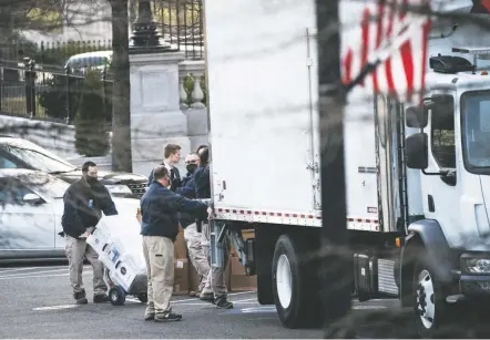  ?? JABIN Botsford/the Washington Post ?? Workers load boxes into a truck at the Eisenhower Executive Office Building on Jan. 14, 2021, in D.C. The FBI received a formal referral from the National Archives and Records Administra­tion about missing classified records that could be in Trump’s possession.
