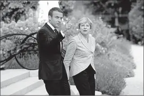  ?? AP/THIBAULT CAMUS ?? French President Emmanuel Macron and British Prime Minister Theresa May arrive for a joint news conference Tuesday after a meeting at the Elysee Palace in Paris.