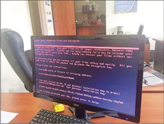  ??  ?? A computer screen cyberattac­k warning notice reportedly holding computer files to ransom, as part of a massive internatio­nal cyberattac­k, at an office in Kiev, Ukraine on June 27. A new and highly virulent outbreak of malicious data-scrambling software...