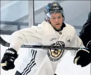  ?? NANCY LANE / BOSTON HERALD FILE ?? Bruins left wing Anders Bjork battles behind the net during training camp at Warrior Ice Arena on Jan. 7.