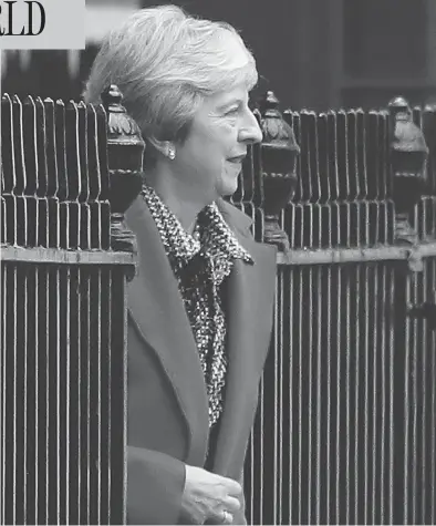  ?? DANIEL LEAL-OLIVAS/AFP/GETTY IMAGES ?? Britain’s Prime Minister Theresa May leaves 10 Downing Street in central London on Friday after battling to salvage a draft Brexit deal and her own political future. She later faced the public to defend her position, in a radio phone-in.