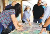  ?? OFFICE OF THE GOVERNOR OF NEW MEXICO VIA AP ?? Gov. Michelle Lujan Grisham (center) meets with officials as she surveys wildfire damage Tuesday.