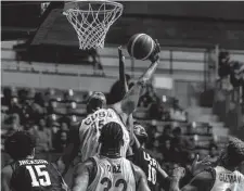  ?? Ramon Espinosa/associated Press ?? Will Davis (10) of the United States fights for the ball with Cuba’s Marvin Cairo (15) during a qualifying game Monday in Havana for next year’s Basketball World Cup.