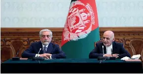  ?? AP ?? Afghan President Ashraf Ghani, right, and political rival Abdullah Abdullah speak after they signed a power-sharing agreement at the presidenti­al palace in Kabul.