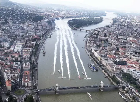  ?? Picture: AFP ?? Peter Besenyei of Hungary, third left, leading Petr Kopfstein of the Czech Republic, Michael Goulian of the United States, Matt Hall of Australia and Ben Murphy of Great Britain over Budapest before the fourth stage of the Red Bull Air Race World...