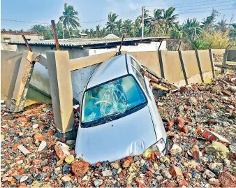  ?? PTI ?? A vehicle partially buried in the debris of a damaged structure at Shankarpur village area in the aftermath of Cyclone Yaas, in East Midnapore district on Friday. —