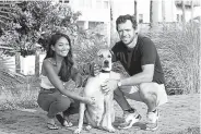  ?? Charlotte Kesl, © The New York Times Co. ?? Maya Brown and Lanto Griffin and their dog, Troy, who has driven with the couple around the Eastern United States.