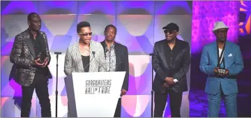  ??  ?? James ‘JT’ Taylor (second from left) gives a speech on stage as George Brown (left to right), Robert ‘Kool’ Bell, Ronald Bell and Dennis Thomas of Kool & The Gang listen during the Songwriter­s Hall of Fame 49th Annual Induction and Awards Dinner on...