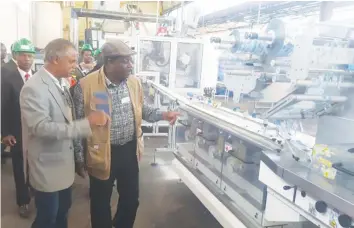  ?? — File Picture ?? The Minister of Industry and Commerce Dr Mike Bimha (right) inspects the soap production line at Willowton Zimbabwe in Mutare last year.