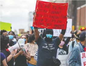  ?? — REUTERS ?? Protesters march in downtown Toronto on Saturday to highlight a police-involved death in the city. The rally was organized by a group called Not Another Black Life.