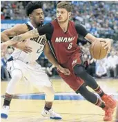  ?? LM OTERO/AP ?? Heat guard Tyler Johnson (8) drives against Dallas Mavericks during the first half Monday in Dallas.