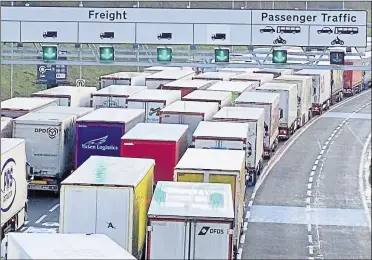  ??  ?? Lorries queue at the Eurotunnel terminal over Christmas