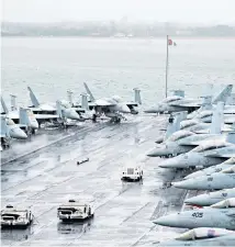  ??  ?? F-18 jets line the deck aboard the US Nimitzclas­s aircraft carrier USS Harry S Truman in Stokes Bay, Hampshire, during a visit to Portsmouth yesterday.