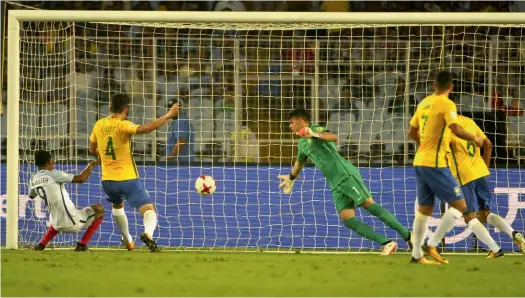  ??  ?? England’s Rhian Brewster (left) scores in their Under-17 World Cup semi-final against Brazil in Kolkata on Wednesday. England won 3-1.