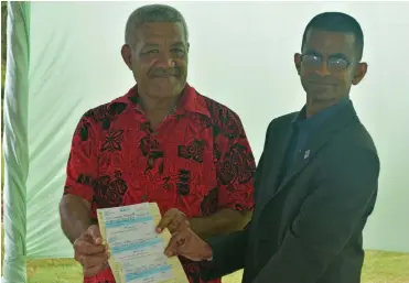  ??  ?? Fiji Hardwood Corporatio­n Limited general manager Shakeel Maharaj handing over the cheques to Dreketi Mahogany Company Limited chairman Kitione Yacadra on September 16, 2019..