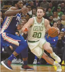  ?? STAFF PHOTO BY CHRIS CHRISTO ?? NICE TO SEE YOU: Gordon Hayward drives against Joel Embiid during the Celtics’ win last night.