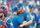  ?? JASON DECROW/AP PHOTO ?? Mets pitcher Noah Syndergaar­d is congratula­ted by teammate David Wright after pitching a complete-game shutout in Sunday’s game against the Miami Marlins at New York.