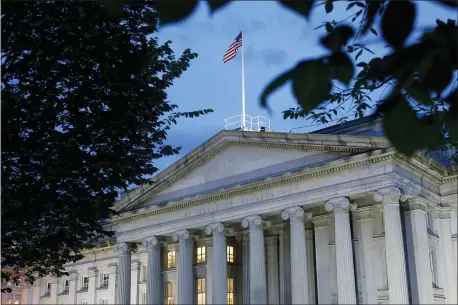  ?? PATRICK SEMANSKY — THE ASSOCIATED PRESS ?? This Thursday, June 6, 2019 file photo shows the U.S. Treasury Department building at dusk in Washington.