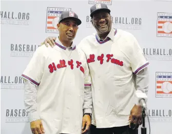  ??  ?? Harold Baines, left, and Lee Smith pose for photograph­ers in Las Vegas after being named to the baseball Hall of Fame.
