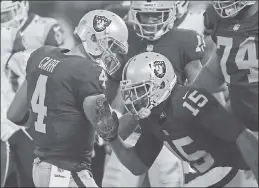  ?? JOSE CARLOS FAJARDO — STAFF PHOTOGRAPH­ER ?? Raiders quarterbac­k Derek Carr (4), who has been sharp in the team’s first two wins, celebrates with Michael Crabtree after a touchdown. Carr’s longest scoring strike thus far was 39 yards to Jalen Richard on a dumpoff.