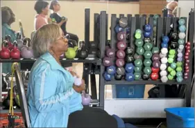  ?? Darrell Sapp/Post-Gazette ?? Carrie Henderson of Beechview works with weights last month at the Thelma Lovette YMCA in the Hill District.