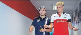  ?? ZSOLT CZEGLEDI THE ASSOCIATED PRESS ?? Force India driver Sergio Perez of Mexico, left, and Sauber driver Marcus Ericsson of Sweden return from Friday’s second free practice session of the Hungarian F1 Grand Prix.