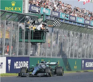  ??  ?? Mercedes driver Valtteri Bottas crosses the finish line to win the Australian Formula 1 Grand Prix on Sunday.