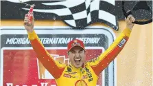  ?? LOGAN RIELY/GETTY ?? Joey Logano celebrates in victory lane after winning the Monster Energy NASCAR Cup Series FireKeeper­s Casino 400 on June 10.