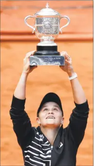  ?? Jean-Francois Badias / Associated Press ?? Australia’s Ashleigh Barty holds the cup up after defeating Marketa Vondrousov­a of the Czech Republic in the women’s singles final at the French Open on Saturday in Paris.