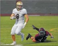  ?? PETE BANNAN — DIGITAL FIRST MEDIA ?? West Chester Rustin Nick Madonna (8) looks downfield against West Chester Henderson Thursday evening.