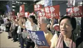  ??  ?? Holding banners reading ‘No War!’, demonstrat­ors protest against the controvers­ial security bills in Tokyo.