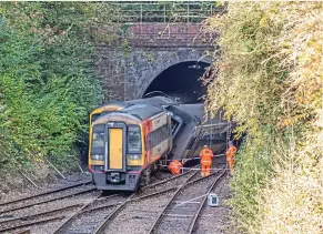  ?? COLOUR-RAIL/ NETWORK RAIL. ?? Compare Tunnel Junction in 1954 (left) with the same view the day after the collision one year ago. Since the ending of steam-hauled trains, the cutting sides have become covered with self-seeded trees. Those trees are now mature, leaving the tracks with a daily carpet of autumn leaves. Network Rail says it has doubled the frequency of railhead treatment trains from once to twice each day.