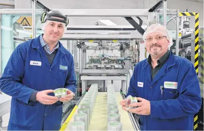  ?? PHOTOS: LINDA ROBERTSON ?? Quality control . . . Packit Packaging operations manager Chris McBride (left) and general manager Jamie Hodgins inspect one of the containers they make. Below: The raw polypropyl­ene pellets they use to create the number five products.