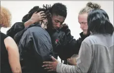  ?? SEAN RAYFORD VIA AP ?? PEOPLE COMFORT EACH OTHER after a vigil for a group of Americans recently kidnapped in Mexico, at Word of God Ministries in Scranton, S.C., on Wednesday.