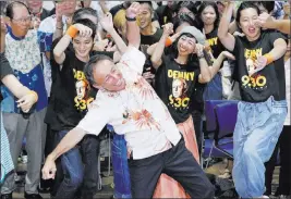  ?? Takuto Kaneko ?? The Associated Press Legislator Denny Tamaki, a critic of the U.S. presence in Okinawa, celebrates his victory in the governor’s race Sunday in Naha.