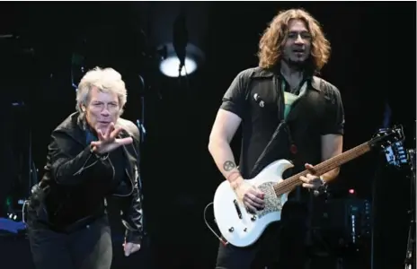  ?? ETHAN MILLER/GETTY IMAGES ?? Jon Bon Jovi, left, Toronto’s Phil (Phil X) Xenidis and the rest of Bon Jovi played to a full house at the ACC Monday night.