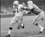  ?? Preston Stroup The Associated Press ?? Green Bay Packers fullback Jim Taylor (31) is brought down by Detroit Lions’ Dick Lane on Nov. 22, 1962, in Detroit. The Hall of Fame fullback died early Saturday, the Packers announced.