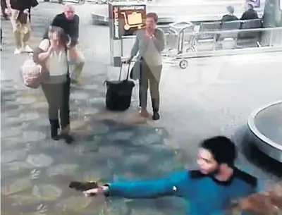  ?? TMZ.COM ?? A frame from a video obtained by TMZ.com appears to show Esteban Santiago opening fire at the Fort Lauderdale airport.