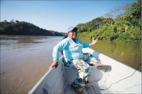  ?? ?? Environmen­talist Isabel Romero sits on a boat Feb. 16 as she talks during an interview on the Magdalena River in Puerto Triunfo.