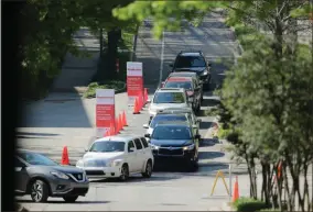  ?? AP-Brynn Anderson ?? A line of cars gather to enter a COVID-19 testing site on Georgia Tech’s campus, Monday in Atlanta.