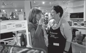  ?? TIM MARTIN/THE DAY ?? Delinda Tucker, left, manager of Elizabeth and Harriet, is comforted by Suzanne Lane, owner of the Gray Goose Cookery and Elizabeth and Harriet in the Elizabeth and Harriet store.